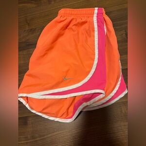 Orange Nike shorts in a medium